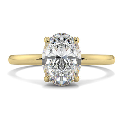 Gold ring with a large diamond on a white background yb_jewellers_solitaire_engagement_ring_best_selling_design_cushion_shape_diamond_4_claw_with_a_slim_band