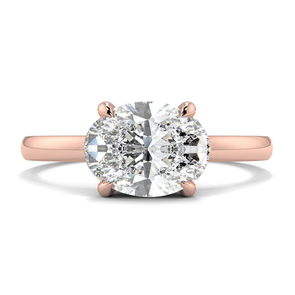 Rose gold ring with a large diamond on a white background yb_jewellers_4_claw_emerald_diamond_engagement_ring_best_selling_design_with_a_thin_band