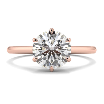 Rose gold ring with a large diamond on a white background yb jewellers solitaire engagement ring with 6 claws set similar to tiffany style classic engagement ring round solitaire diamond ring yb jewellers trending jeweller and ring designs
