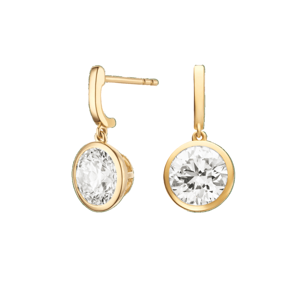 Gold earrings with clear gemstones on a green background  yb jewellers yellow gold diamond drop earrings rubover setting